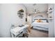 Multi-purpose bedroom and office area with bed, desk, and wall decorations in a well-lit space at 8979 Milestone Dr, Sarasota, FL 34238