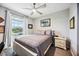 Cozy bedroom features a comfortable bed, bedside table, and a window with a view at 8979 Milestone Dr, Sarasota, FL 34238
