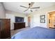 Spacious bedroom features a ceiling fan, television, and multiple closets for ample storage at 8979 Milestone Dr, Sarasota, FL 34238