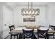 Dining room features a wood table and modern light fixture, perfect for Gathering meals or hosting dinner parties at 8979 Milestone Dr, Sarasota, FL 34238