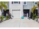 Inviting townhome features a well-manicured front yard and an attached one-car garage at 8979 Milestone Dr, Sarasota, FL 34238