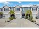 Charming townhomes with well-maintained landscaping, driveways, and two-car garages at 8979 Milestone Dr, Sarasota, FL 34238