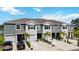The attractive townhome features dual-tone colors, well-manicured lawns, and integrated garage spaces at 8979 Milestone Dr, Sarasota, FL 34238
