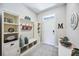 Welcoming foyer features built-in storage, bench, and decor accents at 8979 Milestone Dr, Sarasota, FL 34238