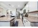 Bright kitchen features a large island and stainless steel appliances with light countertops and white cabinets at 8979 Milestone Dr, Sarasota, FL 34238
