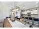 Open concept shows the dining room blending into the kitchen with a large island, stainless steel appliances, and white cabinets at 8979 Milestone Dr, Sarasota, FL 34238
