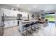 Open concept kitchen has a large island with seating with an adjacent living area for seamless entertaining at 8979 Milestone Dr, Sarasota, FL 34238