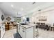 Open concept: kitchen island flows into the living and dining areas, offering a comfortable space for modern living at 8979 Milestone Dr, Sarasota, FL 34238