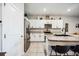 Modern kitchen with granite countertops and stainless steel appliances overlooks the living area at 8979 Milestone Dr, Sarasota, FL 34238