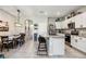 View showcasing the kitchen and dining room in an open concept layout with a large island and dining table at 8979 Milestone Dr, Sarasota, FL 34238