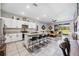 Modern kitchen with granite countertops and stainless steel appliances overlooks the living area at 8979 Milestone Dr, Sarasota, FL 34238