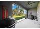 The outdoor patio boasts cooking appliances and a view of the lush backyard and mature trees at 8979 Milestone Dr, Sarasota, FL 34238