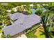 Aerial view of a house with a luxurious roof, attached garage, and screened-in patio area at 8999 Wildlife Loop, Sarasota, FL 34238