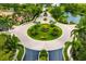 Aerial view of the neighborhood featuring lush landscaping, mature trees, and an elegant roundabout at 8999 Wildlife Loop, Sarasota, FL 34238