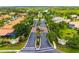 Aerial view of an upscale neighborhood featuring mature trees, luxurious homes, and manicured landscaping at 8999 Wildlife Loop, Sarasota, FL 34238