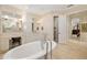 Bright bathroom featuring soaking tub, vanity, and entry to another room at 8999 Wildlife Loop, Sarasota, FL 34238
