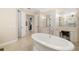 Bright bathroom with soaking tub, vanity, and access to a walk-in closet at 8999 Wildlife Loop, Sarasota, FL 34238