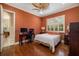 Bedroom with hardwood floors, ceiling fan, and window shutters at 8999 Wildlife Loop, Sarasota, FL 34238
