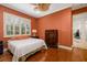 Bedroom features hardwood floors, window with shutters, and wooden dresser at 8999 Wildlife Loop, Sarasota, FL 34238