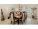 A traditional dining room is enhanced by elegant light fixtures, a large window and beautiful wall art at 8999 Wildlife Loop, Sarasota, FL 34238