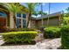 This home features exquisite landscaping, a circular window, and a brick walkway leading to the front door at 8999 Wildlife Loop, Sarasota, FL 34238
