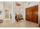 Bright foyer featuring a large double-door entry, travertine flooring and columned archway at 8999 Wildlife Loop, Sarasota, FL 34238