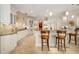 Bright kitchen with white cabinets, granite countertops, and a breakfast bar with seating at 8999 Wildlife Loop, Sarasota, FL 34238