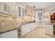 Close-up of the gourmet kitchen showcasing custom cabinetry, granite counters, and modern appliances at 8999 Wildlife Loop, Sarasota, FL 34238