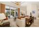 Elegant living room with a ceiling fan, large sliding glass doors to the lanai, and stylish decor at 8999 Wildlife Loop, Sarasota, FL 34238