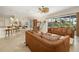 Spacious living room features a ceiling fan and sliding glass doors to the pool area at 8999 Wildlife Loop, Sarasota, FL 34238