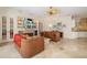 Cozy living room featuring a fireplace, built-in shelving, and comfortable furnishings at 8999 Wildlife Loop, Sarasota, FL 34238
