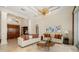 Bright and open living room features high ceilings, travertine floors, neutral colors and elegant decor at 8999 Wildlife Loop, Sarasota, FL 34238