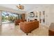 Comfortable living room with view to the screened in pool area and backyard at 8999 Wildlife Loop, Sarasota, FL 34238