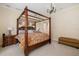 Warm bedroom featuring a four-poster bed, ensuite, ambient lighting, and carpet at 8999 Wildlife Loop, Sarasota, FL 34238