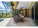 Enjoy outdoor living on the covered patio, which features a dining area with views of the landscaped backyard at 8999 Wildlife Loop, Sarasota, FL 34238