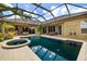 Backyard featuring a private pool, spa, screened lanai and outdoor kitchen at 8999 Wildlife Loop, Sarasota, FL 34238