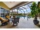 Relaxing screened-in lanai area with a swimming pool, spa, and comfortable seating at 8999 Wildlife Loop, Sarasota, FL 34238