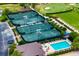 Overhead shot of tennis courts with swimming pool and recreation area at a Gathering-friendly community at 8999 Wildlife Loop, Sarasota, FL 34238