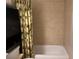 Clean bathroom with tiled walls, white tub, and tropical-themed shower curtain at 900 La Costa Cir # 4, Sarasota, FL 34237