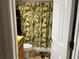 Bathroom showcasing a tropical-themed shower curtain and palm tree bath mat at 900 La Costa Cir # 4, Sarasota, FL 34237