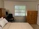 Bedroom featuring a built-in desk, wardrobe and large window overlooking greenery at 900 La Costa Cir # 4, Sarasota, FL 34237