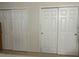 Bedroom featuring two white sliding-door closets for ample storage space at 900 La Costa Cir # 4, Sarasota, FL 34237