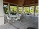 A clubhouse patio with tables and chairs, providing a communal space for residents at 900 La Costa Cir # 4, Sarasota, FL 34237