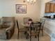 Cozy dining area with a glass table, seating for four, and a view into the adjacent kitchen at 900 La Costa Cir # 4, Sarasota, FL 34237
