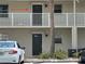 Exterior view showcasing unit #4, set on a balcony above unit #3, with convenient parking and landscaping at 900 La Costa Cir # 4, Sarasota, FL 34237