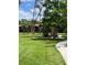 Manicured lawn with mature trees and landscaping surrounding the building at 900 La Costa Cir # 4, Sarasota, FL 34237