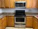 Kitchen featuring stainless steel appliances, granite countertops, and light wood cabinets for ample storage at 900 La Costa Cir # 4, Sarasota, FL 34237