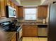 Well-equipped kitchen features matching appliances, granite countertops, stainless sink, and warm cabinets at 900 La Costa Cir # 4, Sarasota, FL 34237