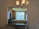 Kitchen view showcasing a pass-through breakfast bar, granite countertops, and warm wooden cabinetry at 900 La Costa Cir # 4, Sarasota, FL 34237
