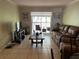 Comfortable living room with tile floors and sliding glass doors to the balcony at 900 La Costa Cir # 4, Sarasota, FL 34237